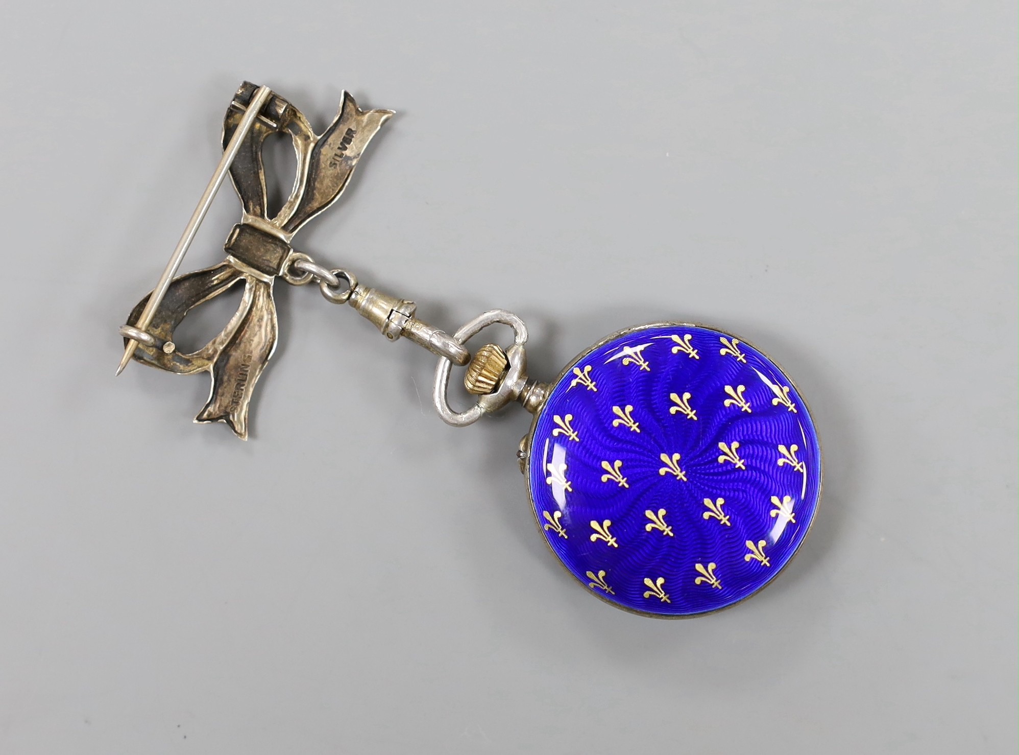 A Swiss white metal and enamel fob watch, on an white metal and enamel suspension bow brooch.